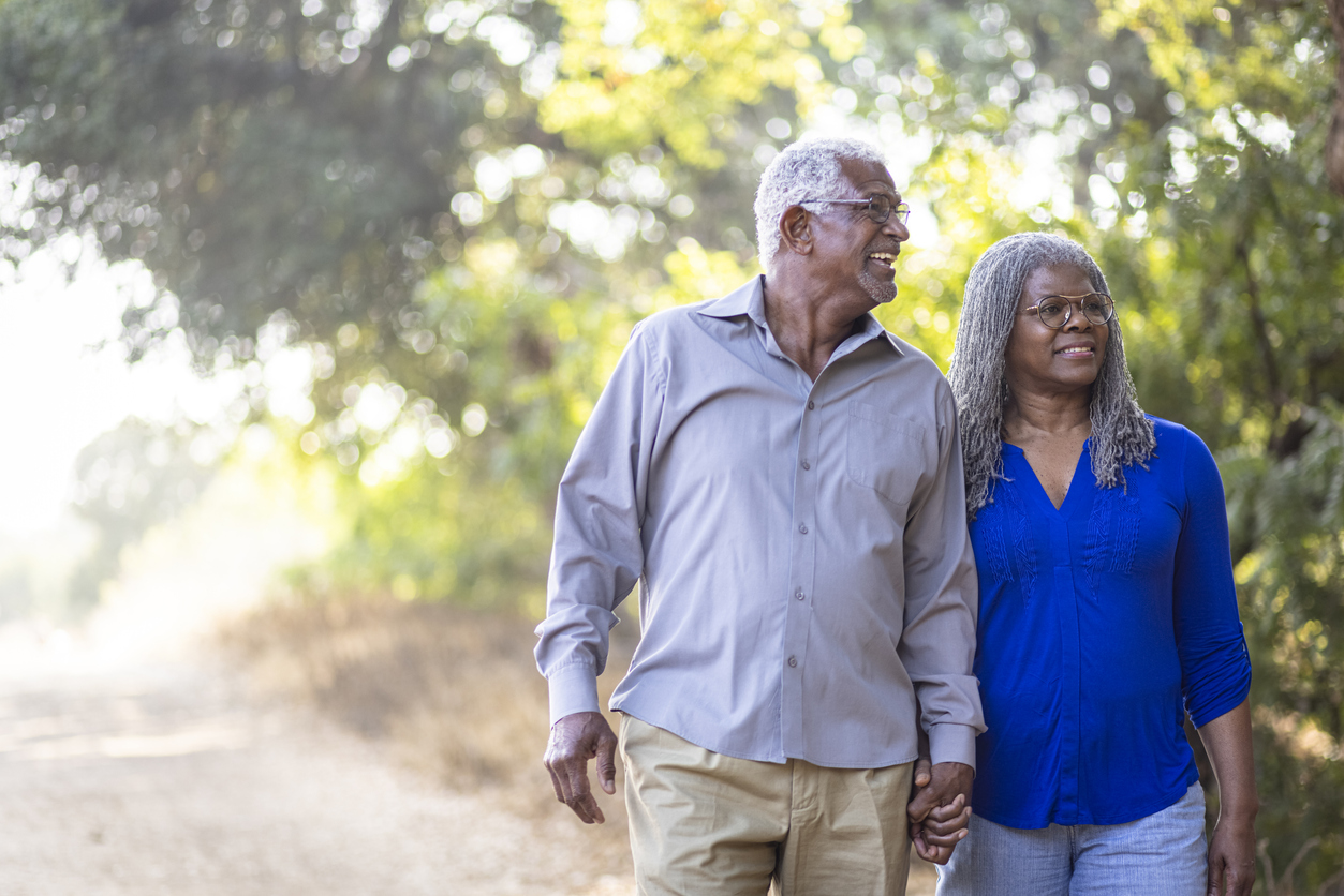 Older couple walking outdoors. 